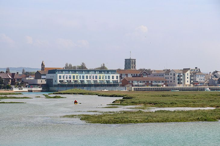 Person paddle boarding down the River Adur in Shoreham